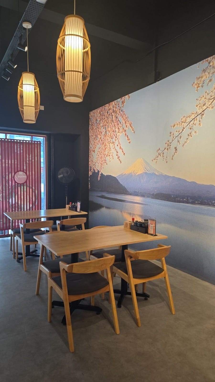 Hanazen's dining room: a Mount Fuji and cherry-blossom mural, bamboo pendant lamps and wooden tables